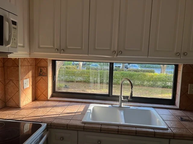 A horizontal sliding window above a kitchen sink.