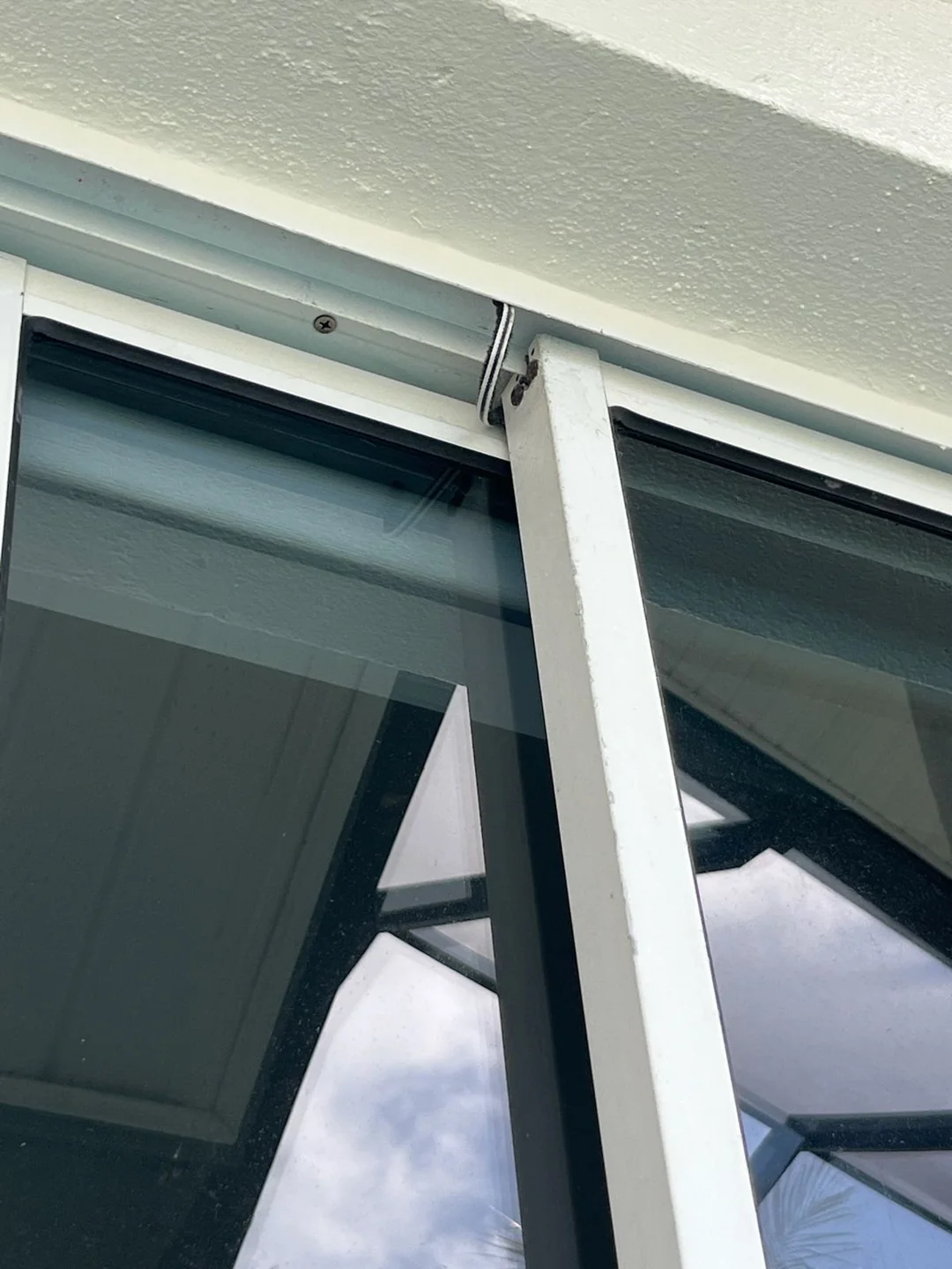 The upper frame and meeting edges of white sliding door panels.