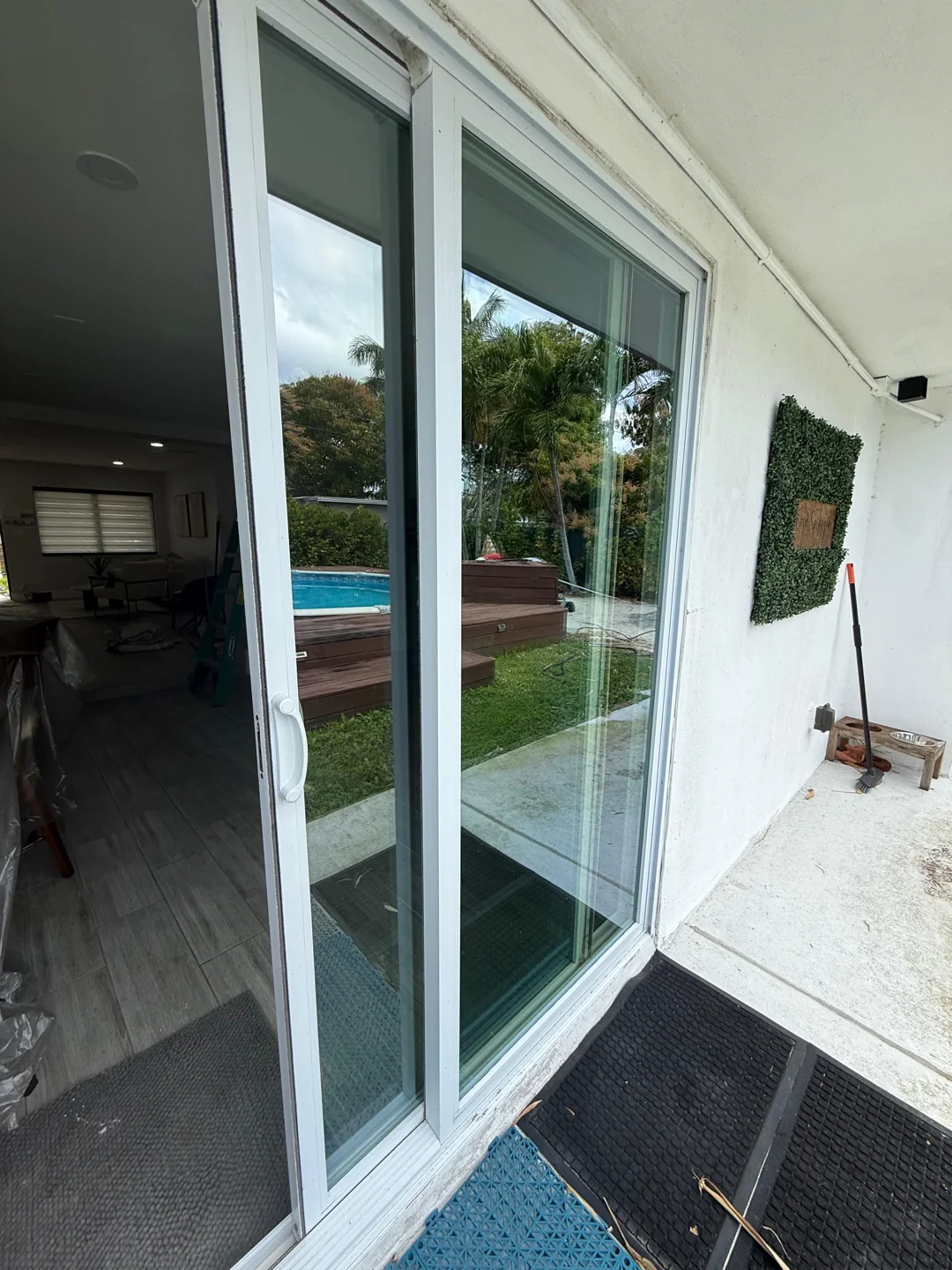 White sliding glass door panels viewed from a covered patio.