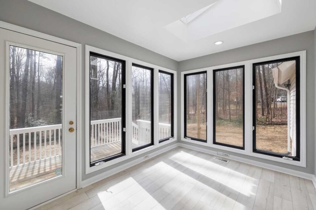 A bright sunroom with large windows, an example of a trusted patio door repair service.